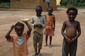 Village children in Zambia with a full cob of Maize 